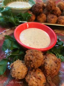 Crispy Reuben Balls are a party's delight. They're filled with savory sauerkraut, chopped corn beef, dipped in an egg batter fried up until they are crispy golden brown. Served with a tangy mustard sauce.