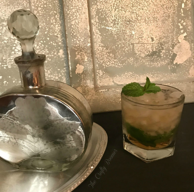 Bourbon, simple syrup, mint and crushed ice is all it takes to make a mint julep Kentucky cocktail.