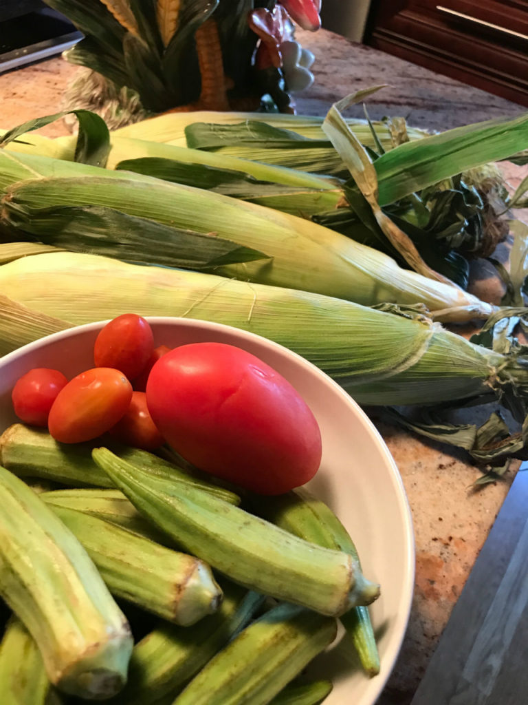 Creamy fried corn with okra and tomatoes is a sure delight to the palate.