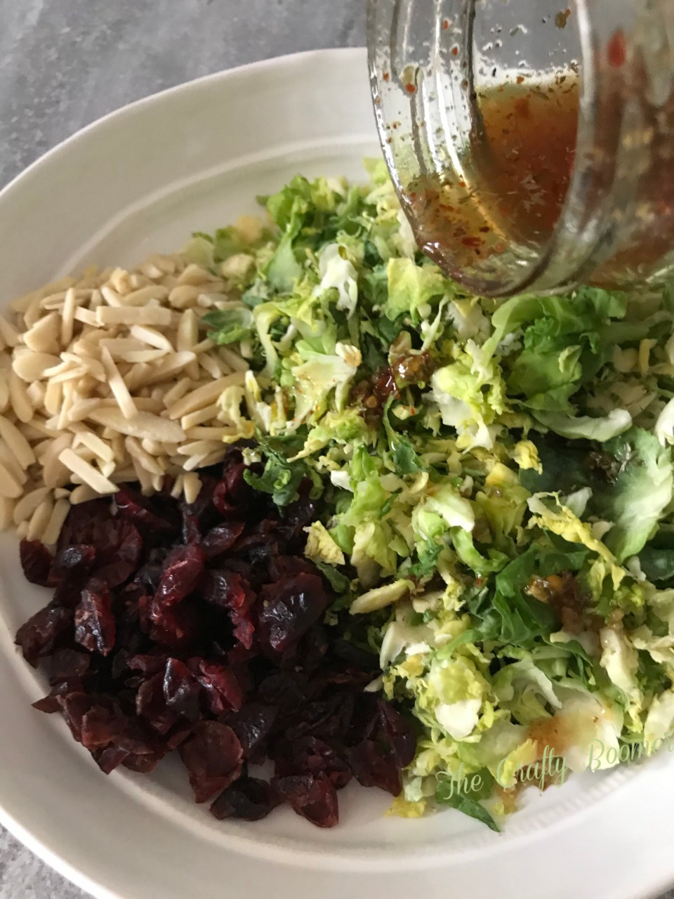 Shaved Brussel Sprouts, dried cranberries, almonds, and dressing makes a simple salad.